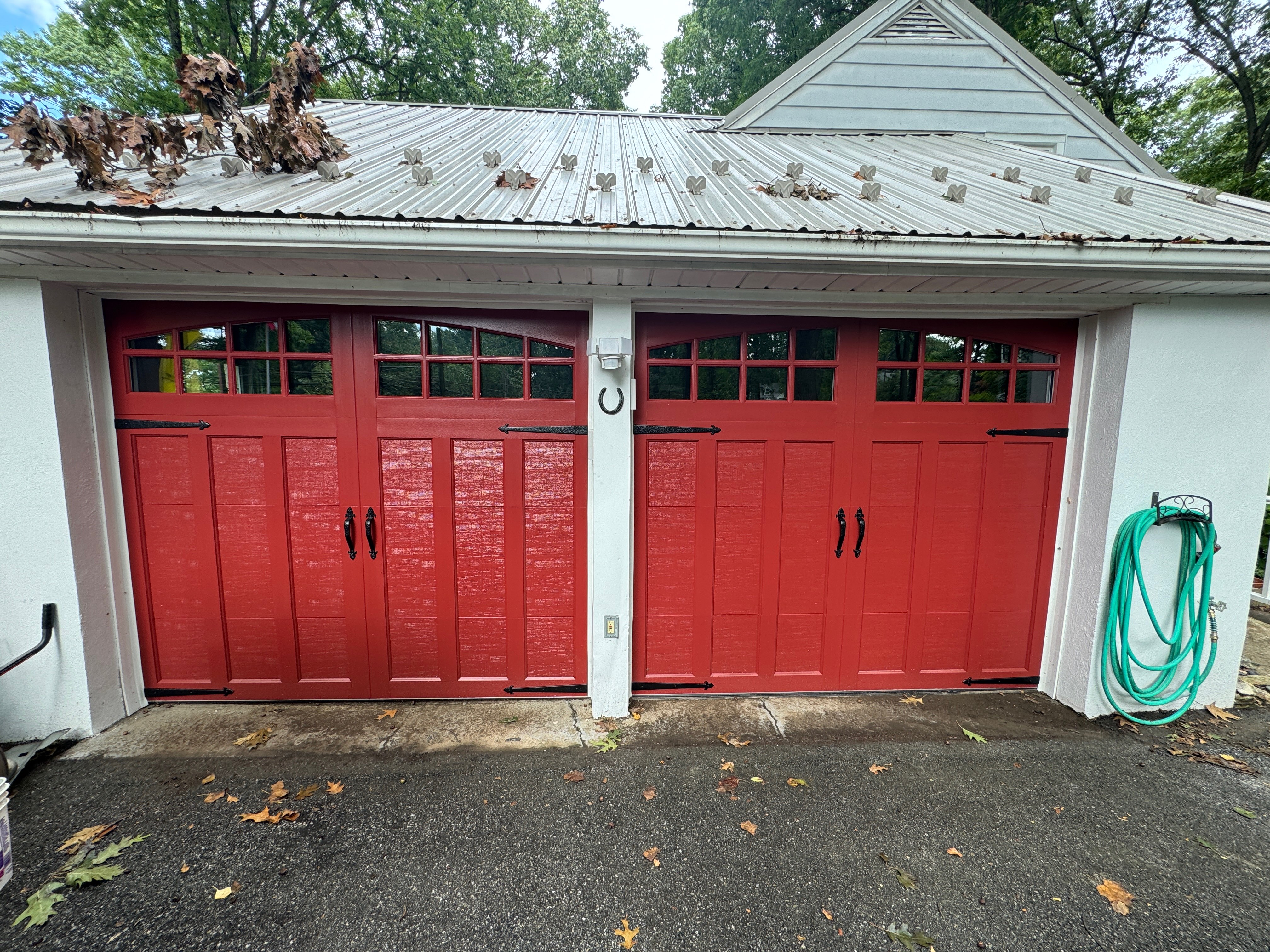 Red carriage style garage doors installed by Bob's Stronghold Doors